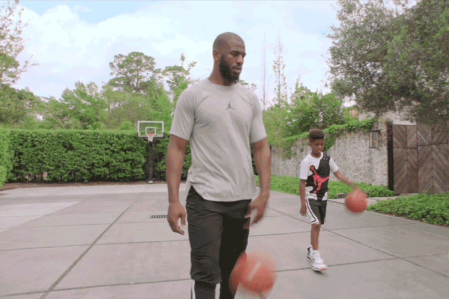 Chris Paul and son dribbling basketballs
