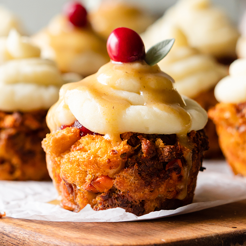 https://cms.beyondmeat.com/graphql/assets/Vegan stuffing cup topped with mashed potatoes, gravy, and a cranberry garnish?access_token=ef24aff5-821d-3250-5fe8-74a46017c003